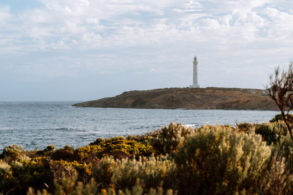 Blick über die Küstenlandschaft auf den weißen Cape Leeuwin Leuchtturm in Augusta